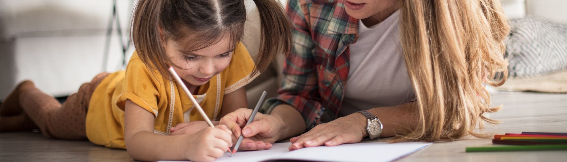 Mother and daughter colouring in book
